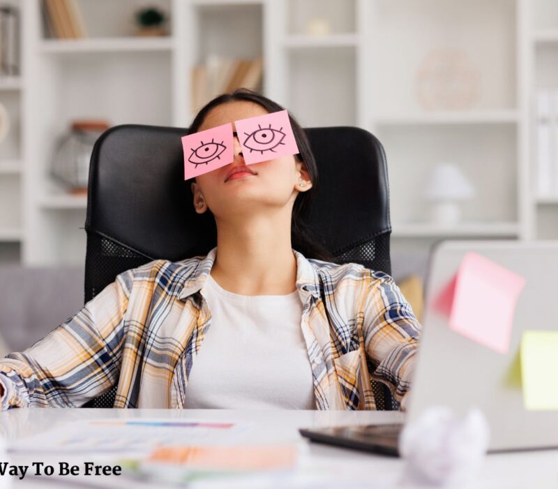 The concept of a lot of work. Tired woman sleeping with stickers on her eyes while sitting at the table. habits to feel better