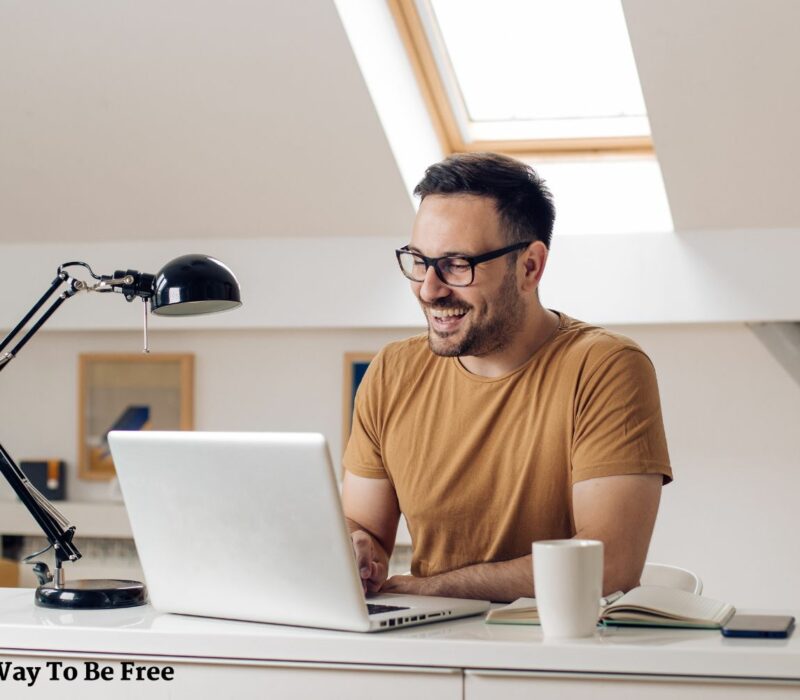 Happy man working from his home office. Mental health benefits of working from home