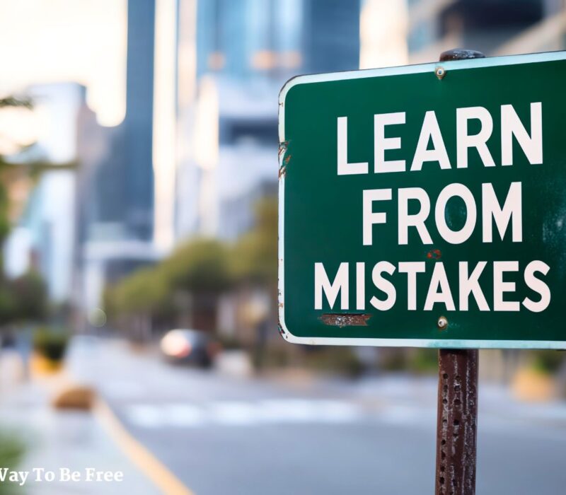 Motivational sign on city street with text 'Learn from Mistakes', emphasizing the importance of learning from errors in life