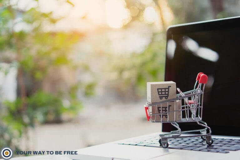 A laptop with a cart that to represent how to scale an e-commerce store