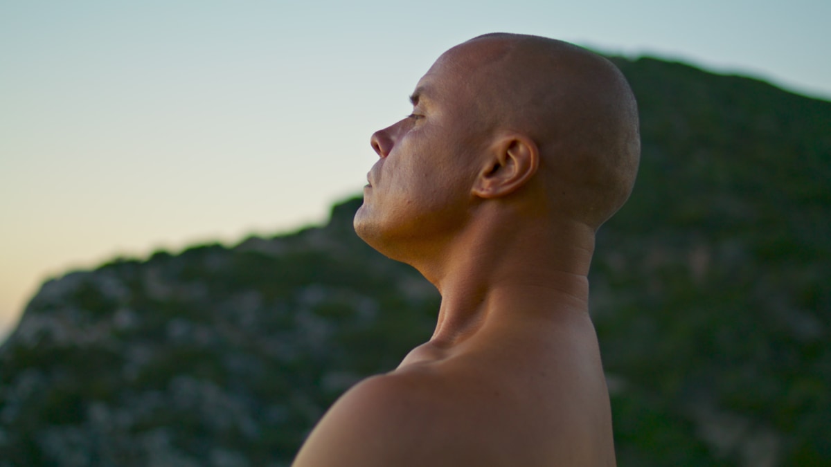 a man meditating in the nature with a free and relaxed mind